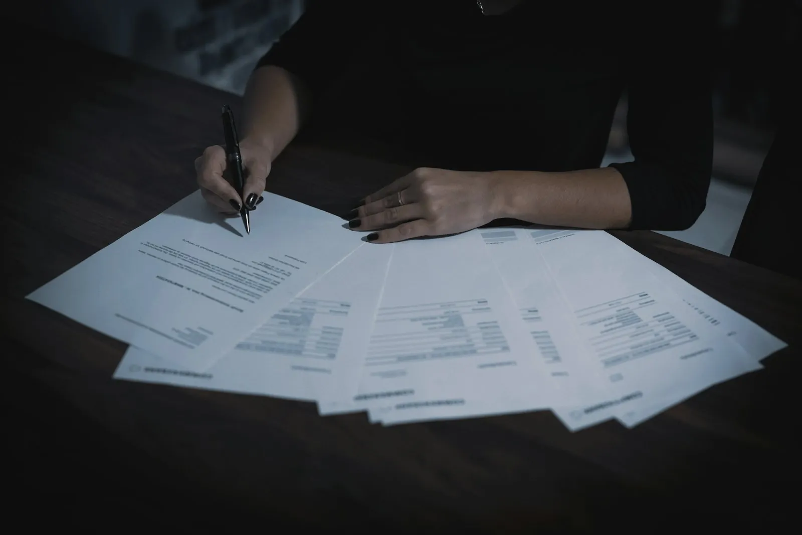 A lawyer marking up papers spread across a table