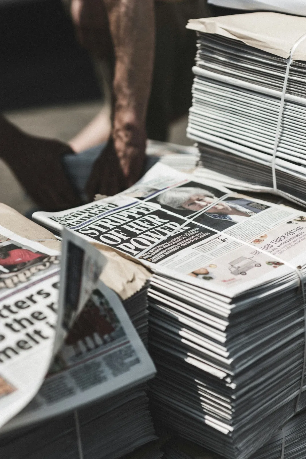 A tall stack of printed newspapers